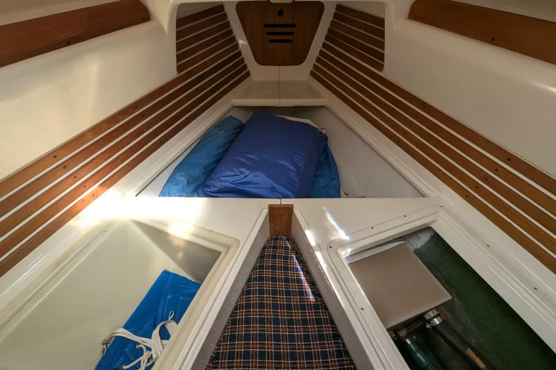 Slide: The Image of Interior cabin of a 1982 Pearson 323 sailboat with wooden accents and storage compartments. - 26