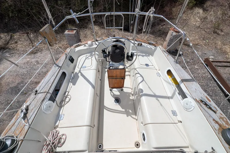 Slide: The Image of Cockpit of a 1982 Pearson 323 sailboat with steering wheel and seating. - 35