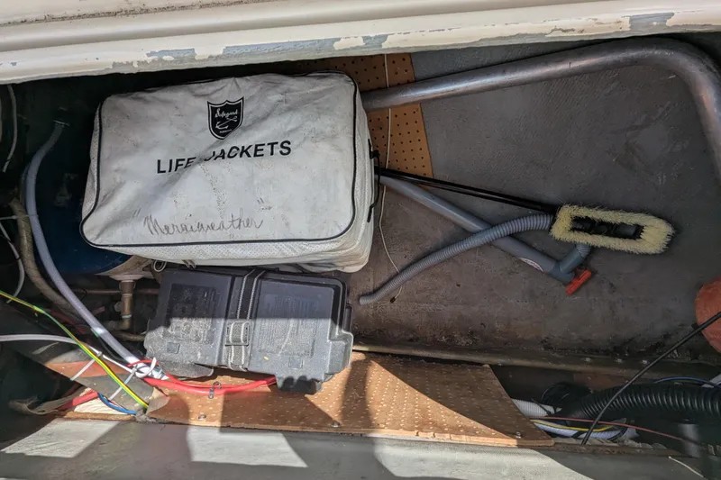 Slide: The Image of Storage compartment of a 1982 Pearson 323 sailboat with life jackets and equipment. - 39