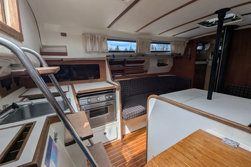 Slide: The Image of Interior of a 1982 Pearson 323 sailboat with kitchen and seating area. - 4