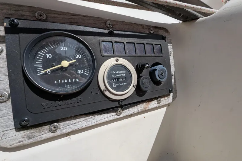 Slide: The Image of Yanmar engine control panel on a 1982 Pearson 323 sailboat, featuring RPM gauge and hour meter. - 41