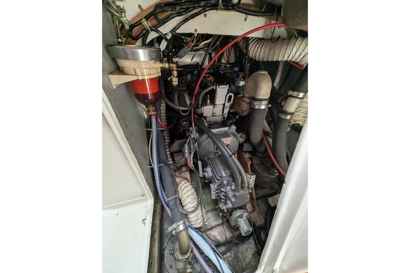 Slide: The Image of Engine compartment of a 1982 Pearson 323 sailboat, showing detailed mechanical components. - 56