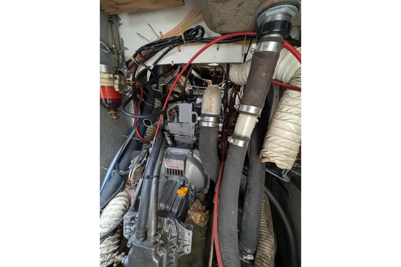 Slide: The Image of Engine compartment of a 1982 Pearson 323 sailboat with visible hoses and wiring. - 57