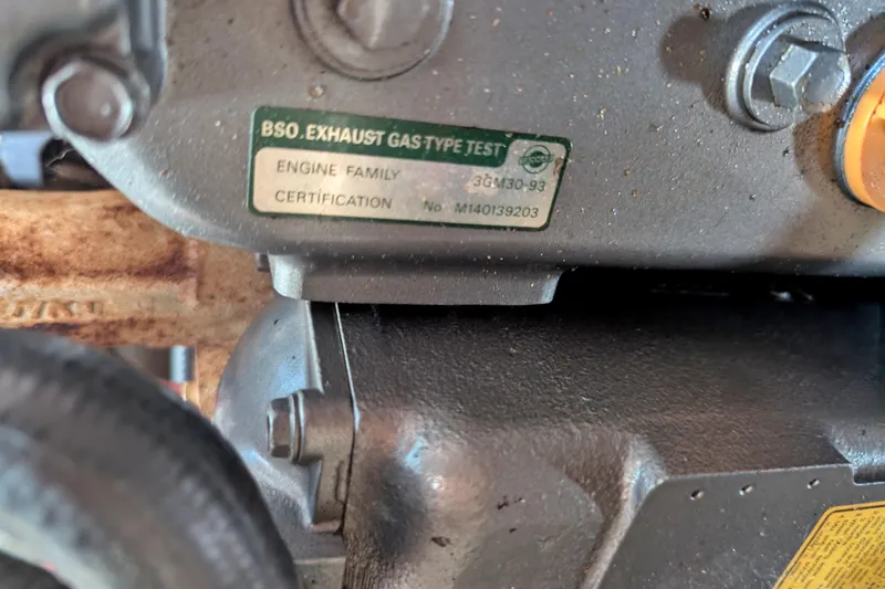 Slide: The Image of Engine certification label on a 1982 Pearson 323, showing exhaust gas type test details. - 60