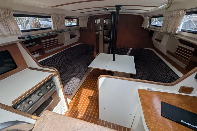 Slide: The Image of Interior of a 1982 Pearson 323 sailboat with wood accents and seating area. - 7