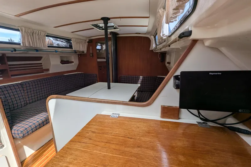 Slide: The Image of Interior of a 1982 Pearson 323 sailboat with seating and table. - 9