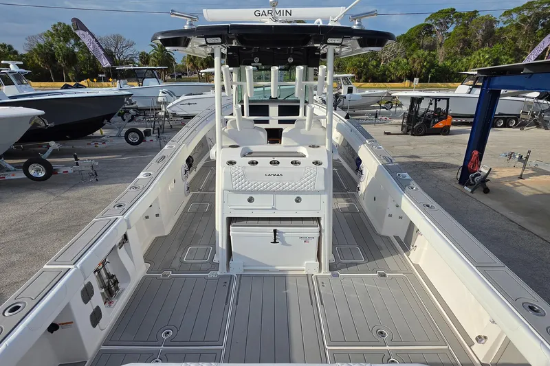 Slide: The Image of 2025 Caymas 34 CT boat with spacious deck and modern features, docked outdoors. - 10