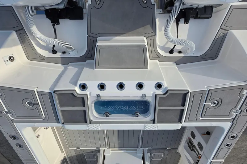 Slide: The Image of 2025 Caymas 34 CT boat deck with storage compartments and hose fittings. - 11