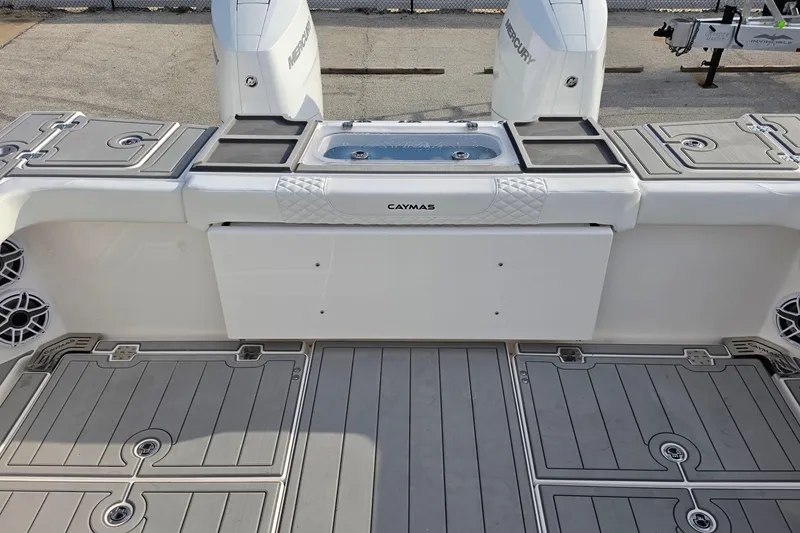 Slide: The Image of 2025 Caymas 34 CT boat deck with Mercury engines and storage compartments. - 13