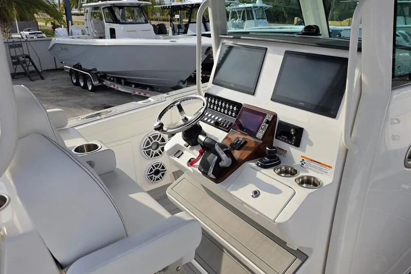 Slide: The Image of 2025 Caymas 34 CT boat cockpit with modern controls and dual screens. - 16