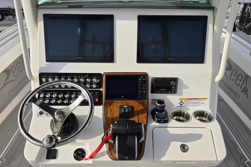 Slide: The Image of Helm of 2025 Caymas 34 CT boat with dual screens and control panel. - 17
