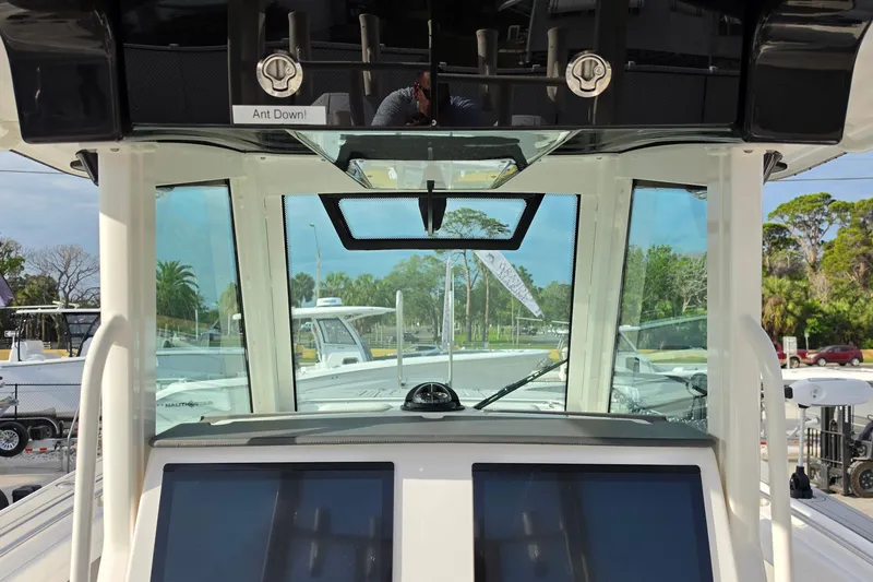 Slide: The Image of 2025 Caymas 34 CT boat cockpit with advanced navigation screens and clear windshield view. - 18