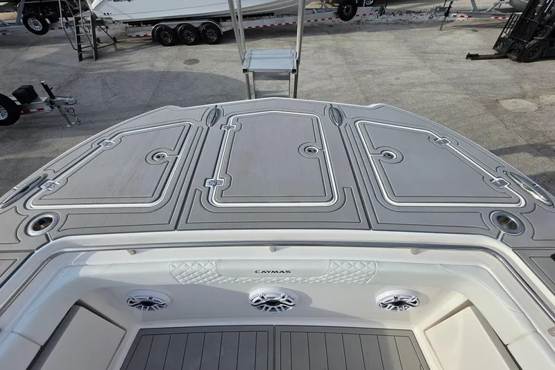 Slide: The Image of 2025 Caymas 34 CT boat deck with storage compartments and speakers. - 23