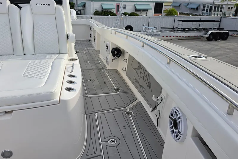 Slide: The Image of 2025 Caymas 34 CT boat interior with white seating and sleek deck design. - 29