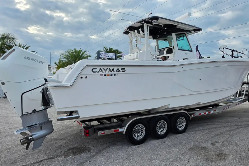 Slide: The Image of 2025 Caymas 34 CT boat on trailer with Mercury engine, parked outdoors. - 3