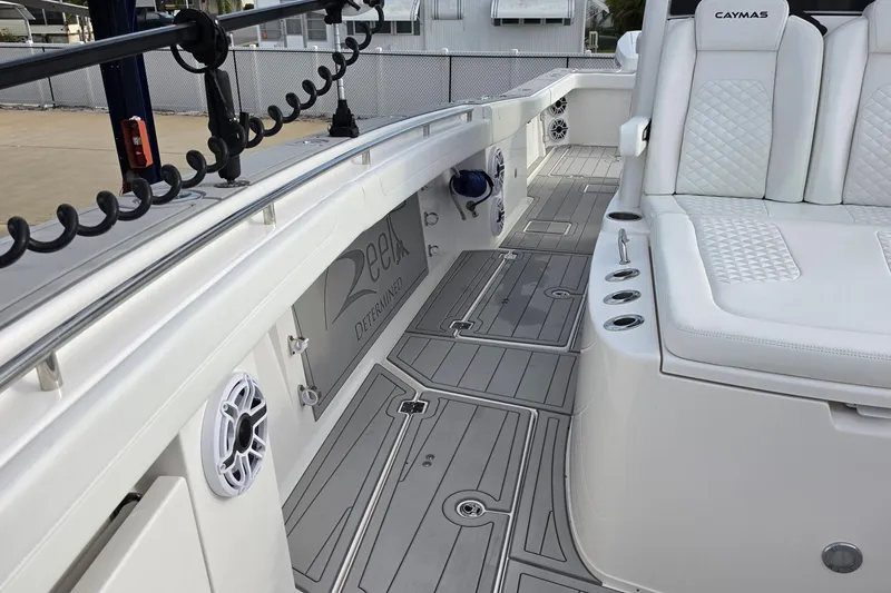 Slide: The Image of 2025 Caymas 34 CT boat interior with white seating and sleek deck design. - 30