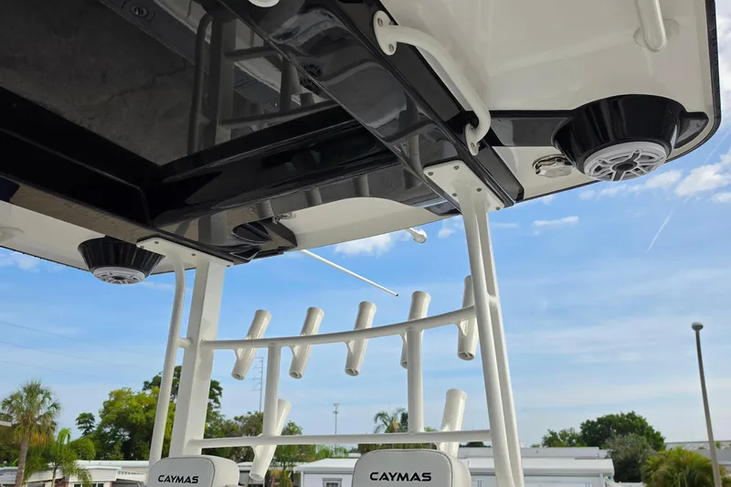 Slide: The Image of 2025 Caymas 34 CT boat with rod holders and speakers, under a clear blue sky. - 32