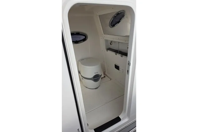Slide: The Image of 2025 Caymas 34 CT boat interior with compact marine toilet and storage. - 33