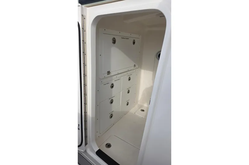 Slide: The Image of Interior storage compartment of 2025 Caymas 34 CT boat, featuring organized cabinetry. - 35