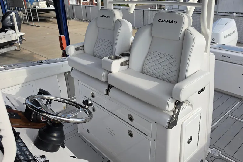 Slide: The Image of 2025 Caymas 34 CT boat interior with dual captain seats and steering wheel. - 36