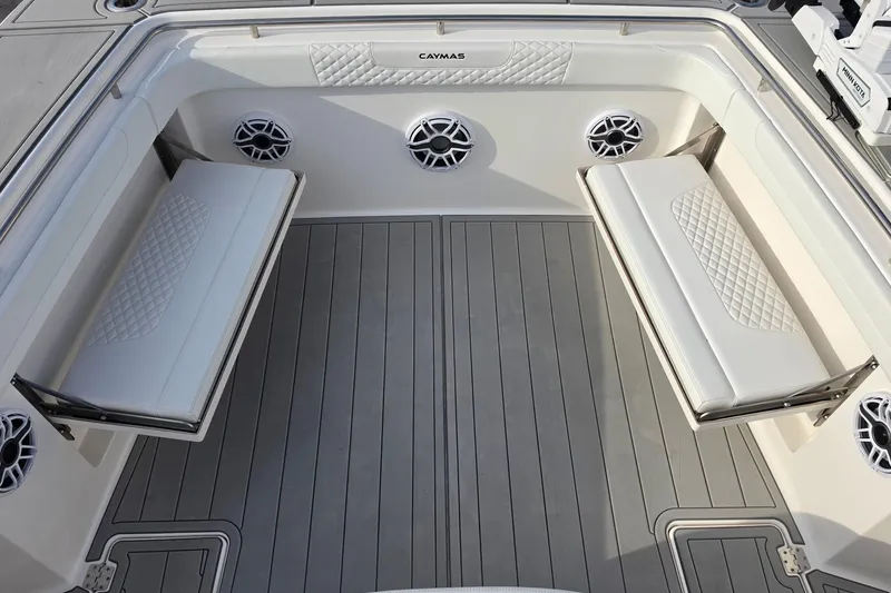 Slide: The Image of 2025 Caymas 34 CT boat interior with cushioned seating and speakers. - 38