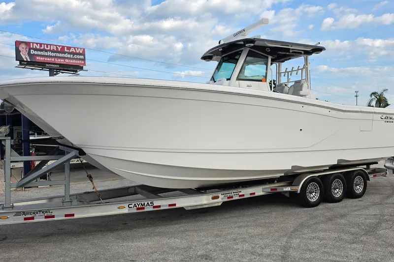 Slide: The Image of 2025 Caymas 34 CT boat on trailer under cloudy sky. - 7