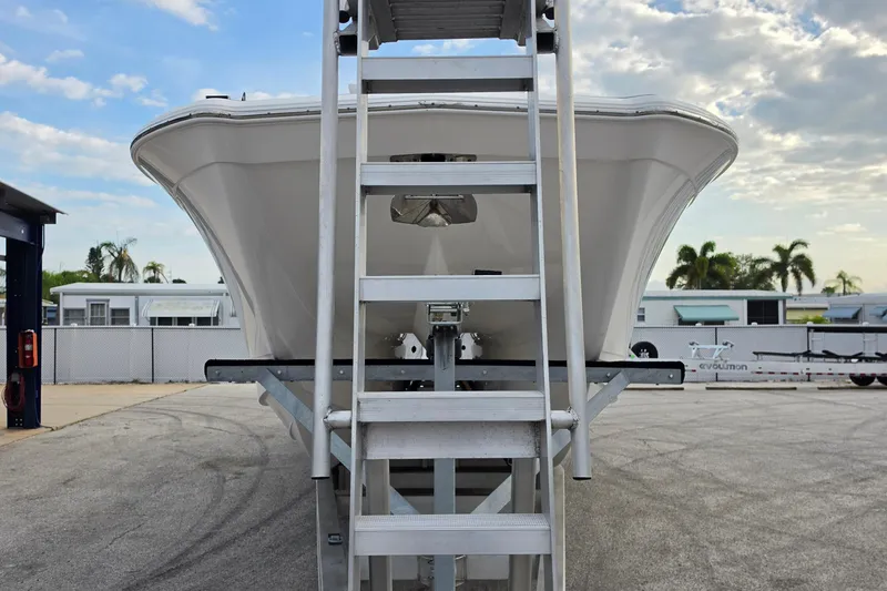 Slide: The Image of 2025 Caymas 34 CT boat on trailer, viewed from front with ladder access. - 8