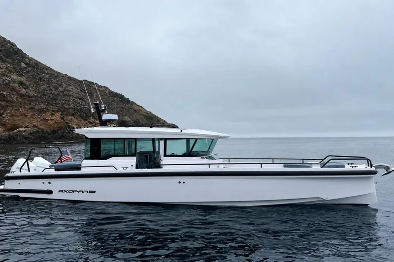 The Image of Axopar Brabus 37 XC Cross Cabin 2023 on calm sea near rocky coastline. - 0