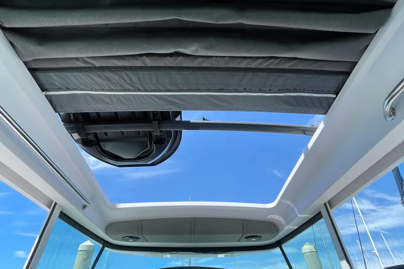 Slide: The Image of Sunroof view from 2023 Axopar 37 XC Cross Cabin, showcasing clear blue sky. - 11