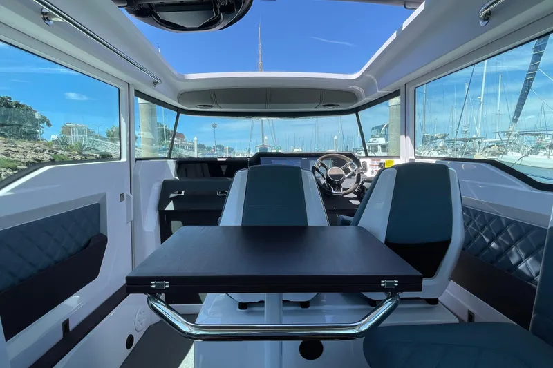 Slide: The Image of Interior of 2023 Axopar 37 XC Cross Cabin with modern seating and panoramic windows. - 12