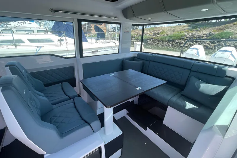 Slide: The Image of Interior of 2023 Axopar 37 XC Cross Cabin with plush seating and table. - 16