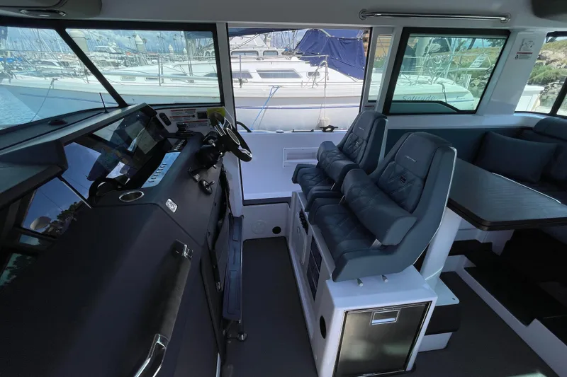 Slide: The Image of Interior of 2023 Axopar 37 XC Cross Cabin with modern seating and navigation controls. - 18