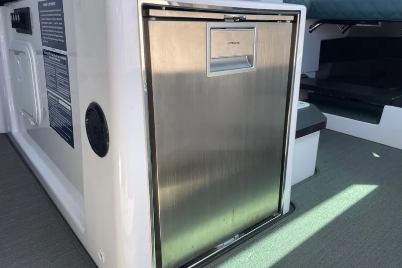 Slide: The Image of 2023 Axopar 37 XC Cross Cabin interior with stainless steel fridge. - 19