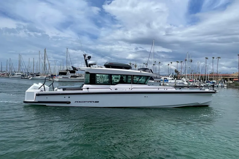 Slide: The Image of 2023 Axopar Brabus 37 XC Cross Cabin in harbor. - 2