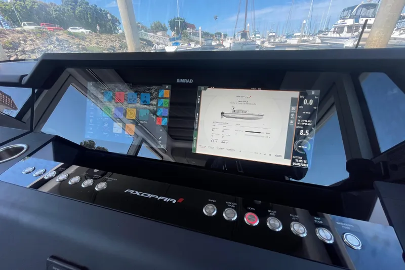Slide: The Image of Dashboard of 2023 Axopar 37 XC Cross Cabin with navigation screens and controls. - 23