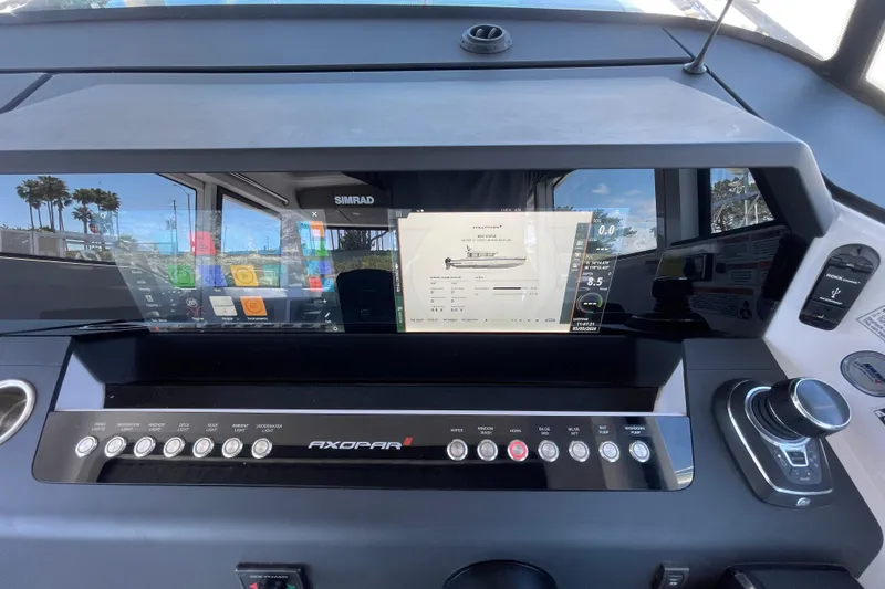 Slide: The Image of 2023 Axopar 37 XC Cross Cabin dashboard with navigation and control panel. - 24