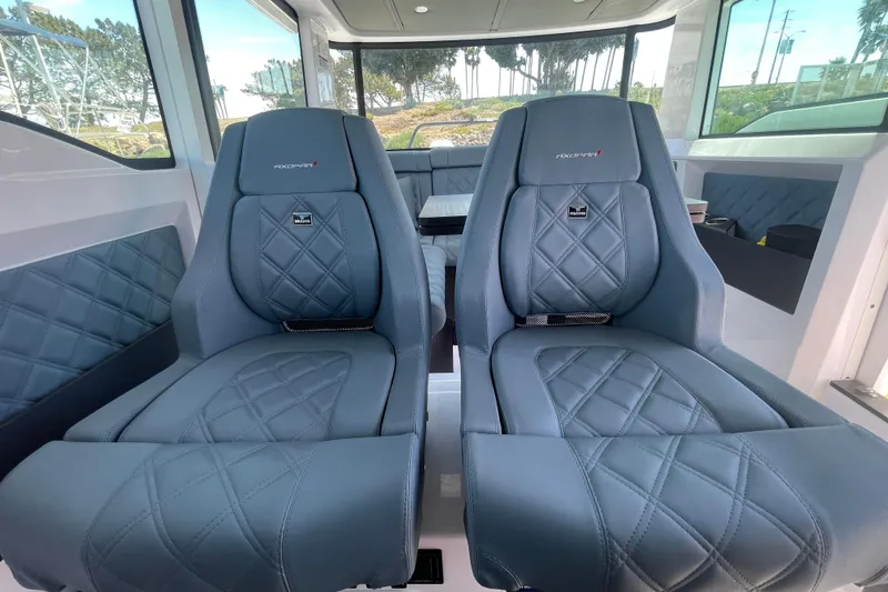 Slide: The Image of 2023 Axopar 37 XC Cross Cabin interior with luxurious blue quilted seats. - 29