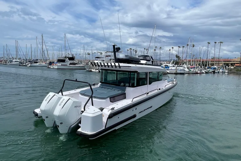 Slide: The Image of 2023 Axopar Brabus 37 XC Cross Cabin in harbor. - 3
