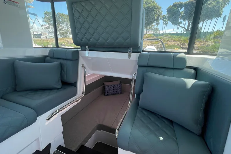 Slide: The Image of Luxurious interior of 2023 Axopar 37 XC Cross Cabin with plush seating and cushions. - 31