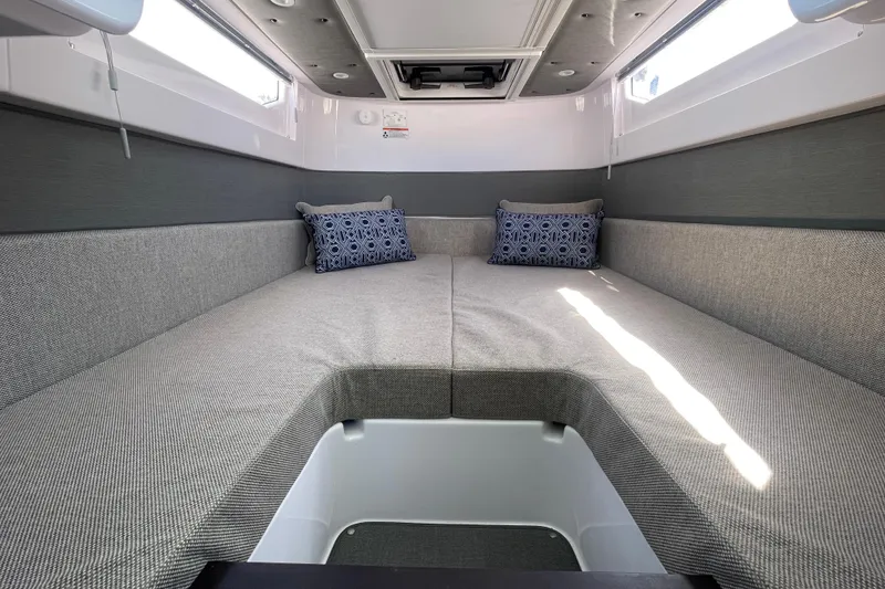Slide: The Image of 2023 Axopar 37 XC Cross Cabin interior with cozy seating and decorative pillows. - 32