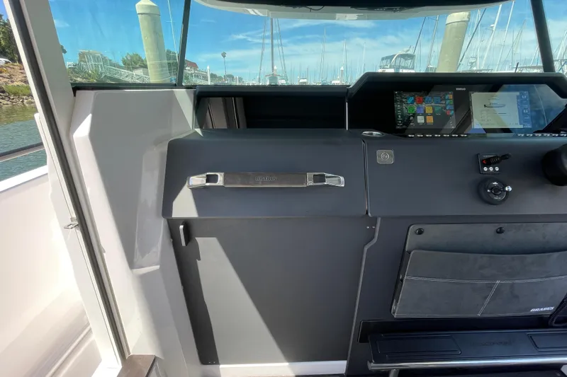 Slide: The Image of 2023 Axopar 37 XC Cross Cabin dashboard with navigation display and controls. - 35