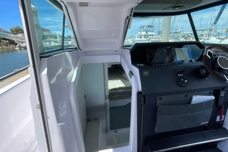Slide: The Image of 2023 Axopar 37 XC Cross Cabin interior with helm and cabin view. - 36