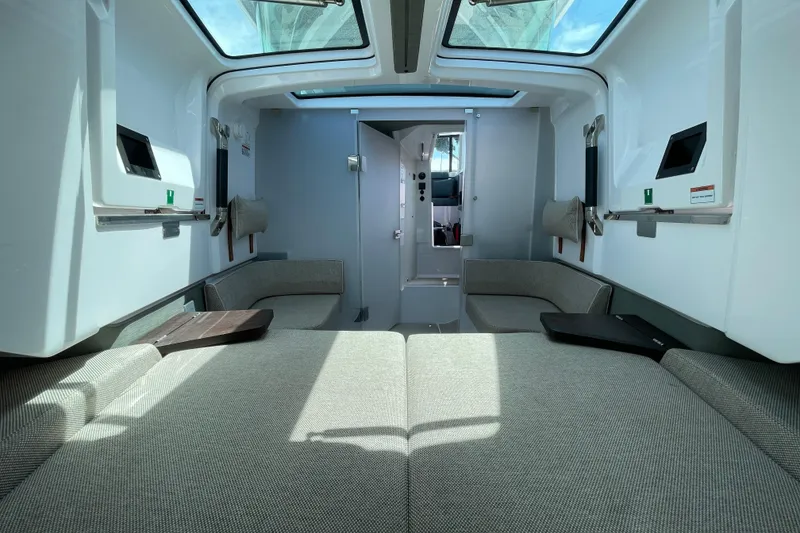 Slide: The Image of Interior of 2023 Axopar 37 XC Cross Cabin, featuring modern seating and skylights. - 38