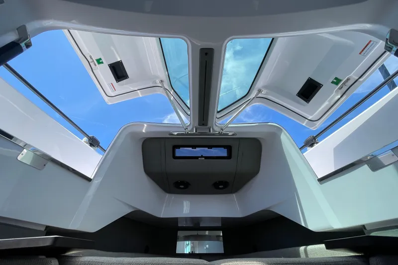Slide: The Image of Interior view of 2023 Axopar 37 XC Cross Cabin with open roof hatches. - 39