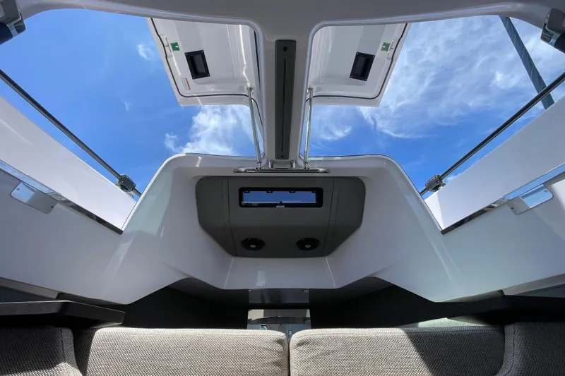Slide: The Image of Interior view of 2023 Axopar 37 XC Cross Cabin with open roof and blue sky. - 40