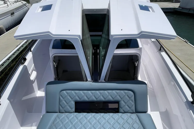 Slide: The Image of 2023 Axopar 37 XC Cross Cabin with open sunroof and quilted seating. - 47