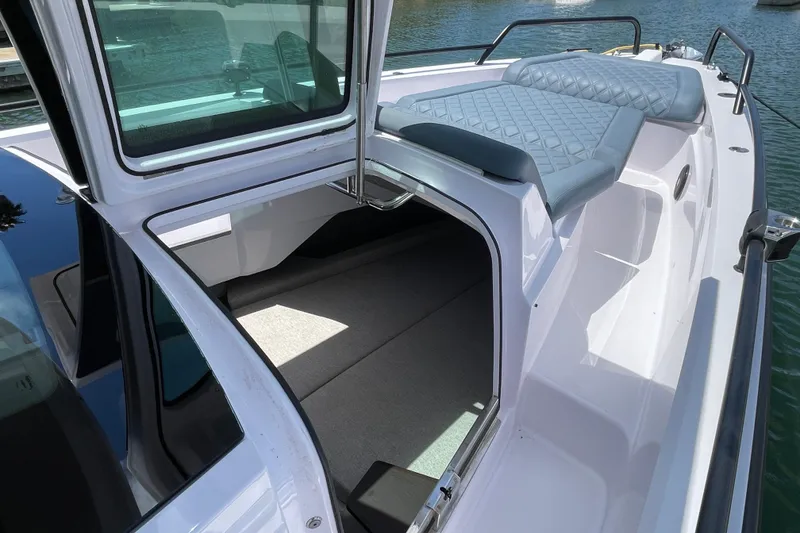 Slide: The Image of 2023 Axopar 37 XC Cross Cabin boat with open cabin and cushioned seating. - 48