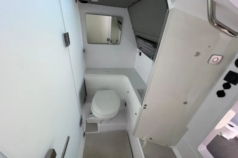 Slide: The Image of 2023 Axopar 37 XC Cross Cabin bathroom with toilet, mirror, and modern design. - 51