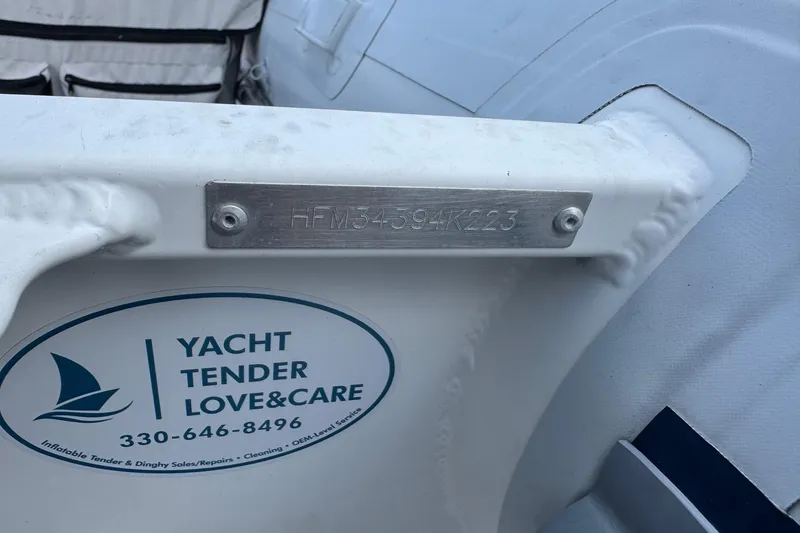 Slide: The Image of 2023 Highfield Ultralite 310 boat with identification plate and service sticker. - 12