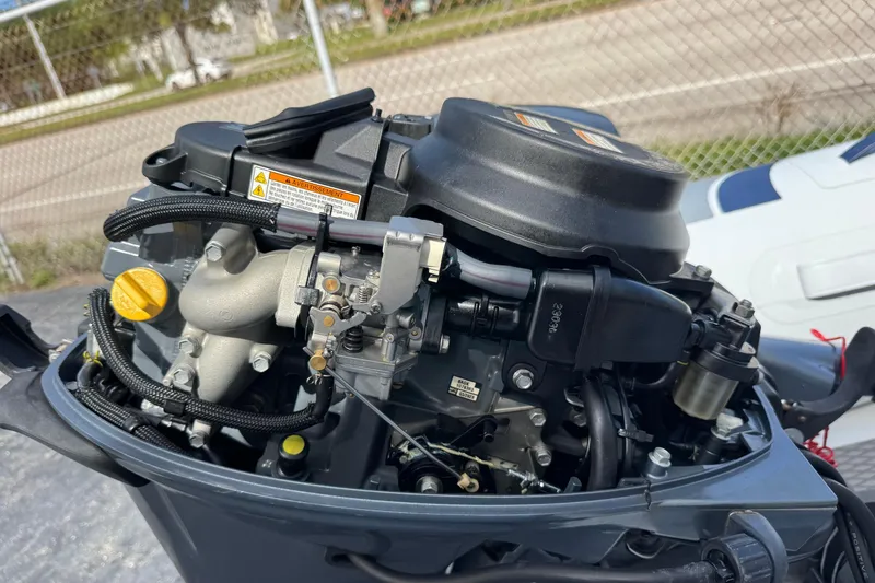 Slide: The Image of 2023 Highfield Ultralite 310 outboard motor close-up, showcasing engine components. - 16